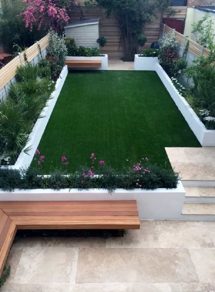 Artificial grass surrounded by plants beds