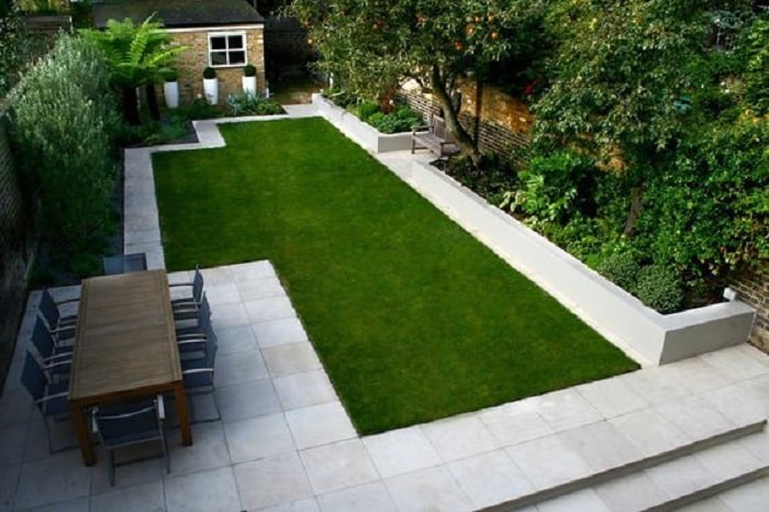 Large backyard with artificial grass and open space dining