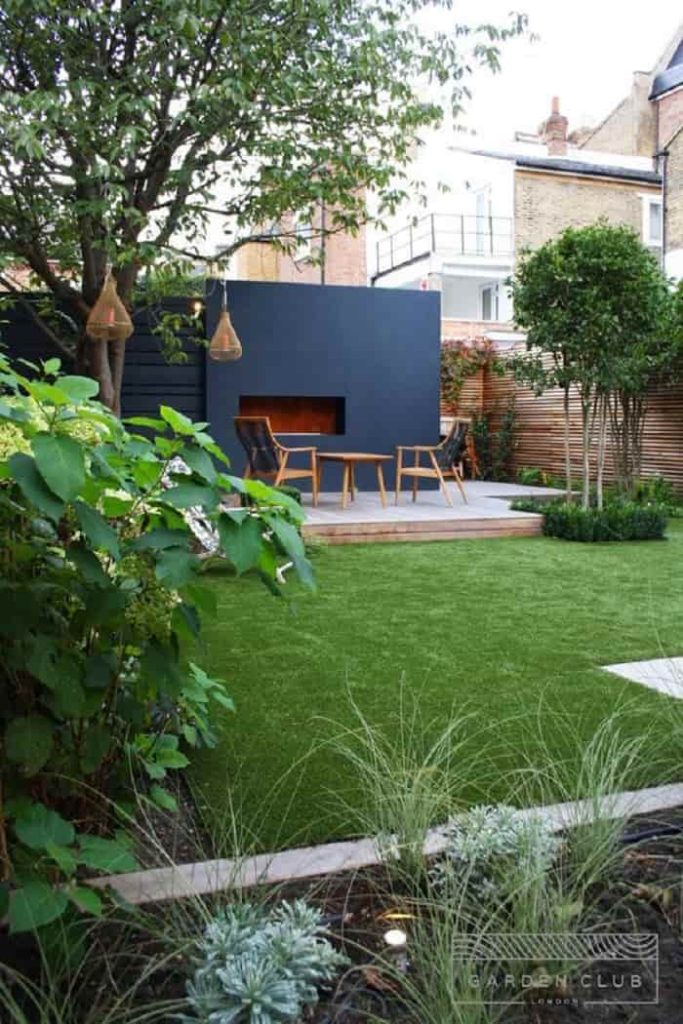 The small garden with artificial grass and a warm seating area