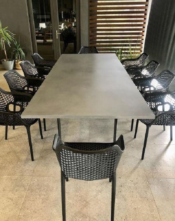 10-seater concrete dining table with thin steel leg as a base