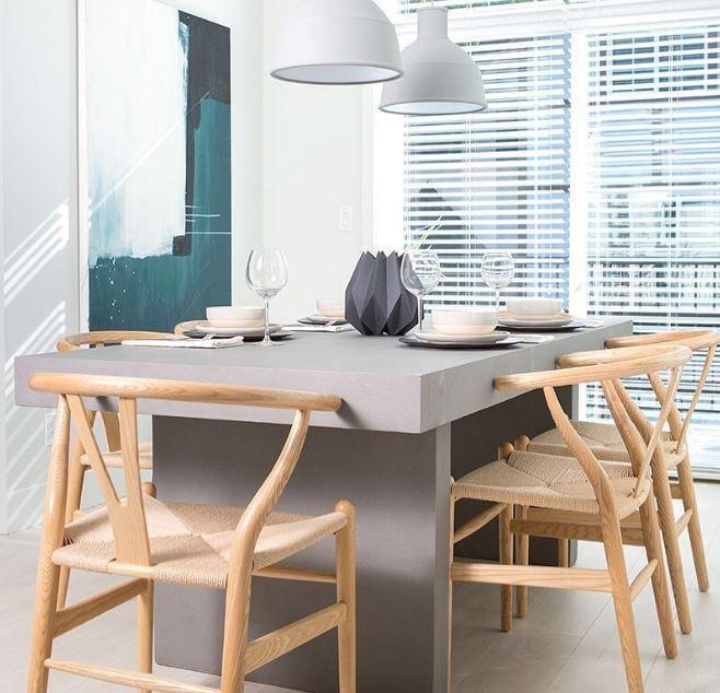 Grey concrete dining table with classic wishbone chair