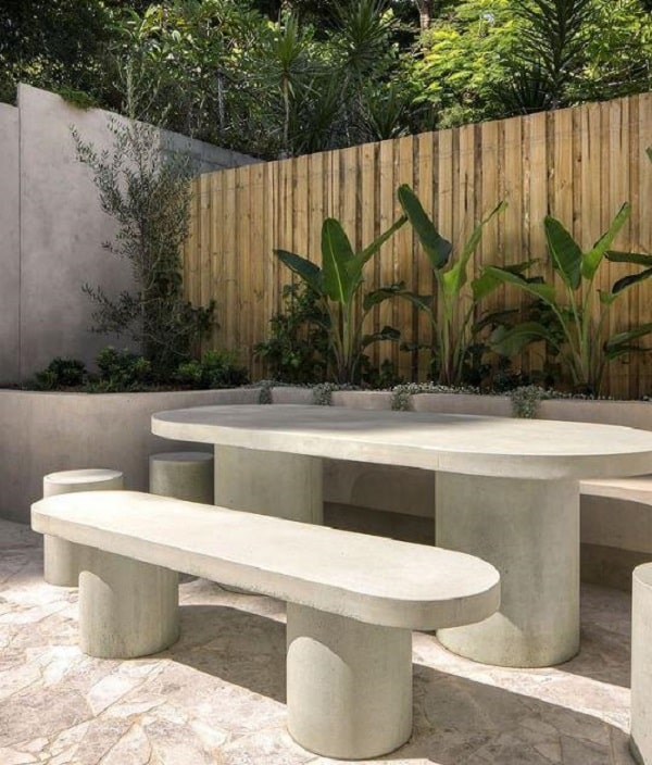 White concrete outdoor dining table on the side garden