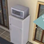 A microwave on top of a fridge