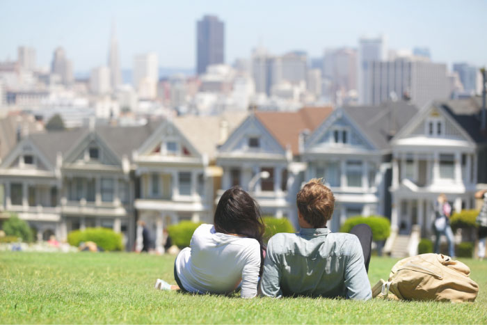 Husband and wife are looking at their rented home from outdoors.