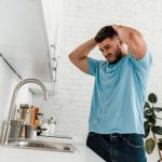 A man is worried because his kitchen sink has stopped working.