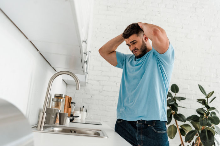 A man is worried because his kitchen sink has stopped working.