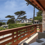 The oceanside view at the property, complete with a deck and comfy chairs