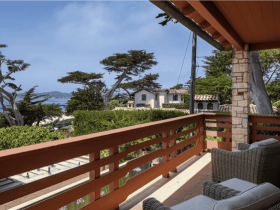 The oceanside view at the property, complete with a deck and comfy chairs