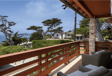 The oceanside view at the property, complete with a deck and comfy chairs