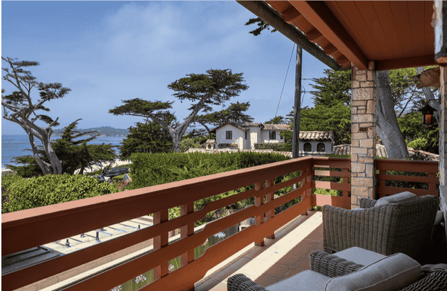 The oceanside view at the property, complete with a deck and comfy chairs