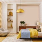 Bedroom Renovating with a Stylish Modern Design Featuring Wooden Bed, Yellow and Blue Bedding, Cozy Lounge Chair, and Warm Golden Lighting