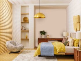 Bedroom Renovating with a Stylish Modern Design Featuring Wooden Bed, Yellow and Blue Bedding, Cozy Lounge Chair, and Warm Golden Lighting