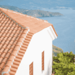 Durable terracotta tiled roof on a coastal building, used to illustrate Long Island roof replacement quality.