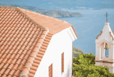 Durable terracotta tiled roof on a coastal building, used to illustrate Long Island roof replacement quality.