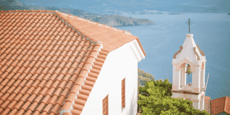 Durable terracotta tiled roof on a coastal building, used to illustrate Long Island roof replacement quality.