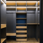 A modern walk-in closet featuring built-in shelves, drawers, and hanging space with integrated lighting.