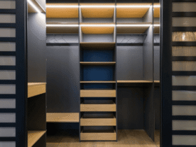 A modern walk-in closet featuring built-in shelves, drawers, and hanging space with integrated lighting.